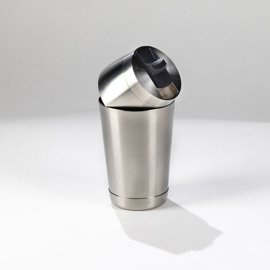 Speed Tin one-handed cocktail shaker top with built-in strainer resting on stainless steel base tin