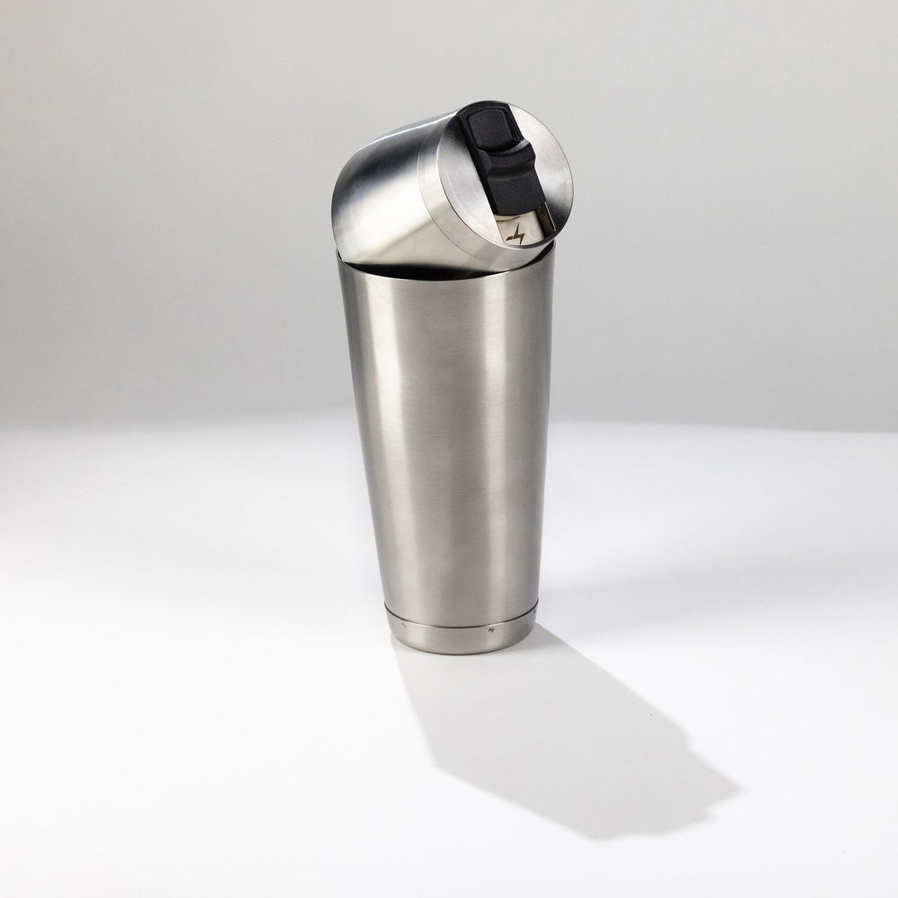 Stainless steel speed tin shaker on a white background