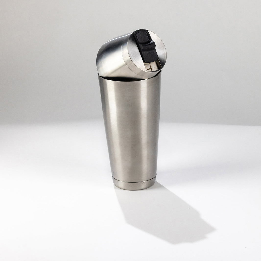 Stainless steel speed tin shaker on a white background
