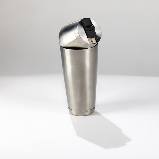 Stainless steel speed tin shaker on a white background